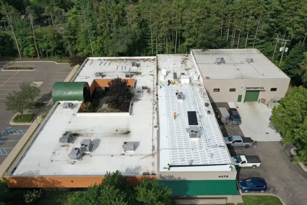 commercial roofing contractor on a process of installing a new Flat Roof in Pontiac, MI