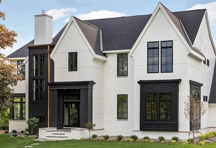 Two-story white house with black windows, trim, and a dark roof by performance roofing and siding in Pontiac, MI