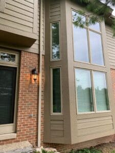 Close-up of damaged LP siding showing signs of wear, moisture exposure, and cracking.