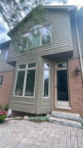 Expert performing a siding inspection to compare James Hardie and LP siding durability.