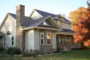 House with multiple siding colors with black roof made by siding contractor in Pontiac, MI