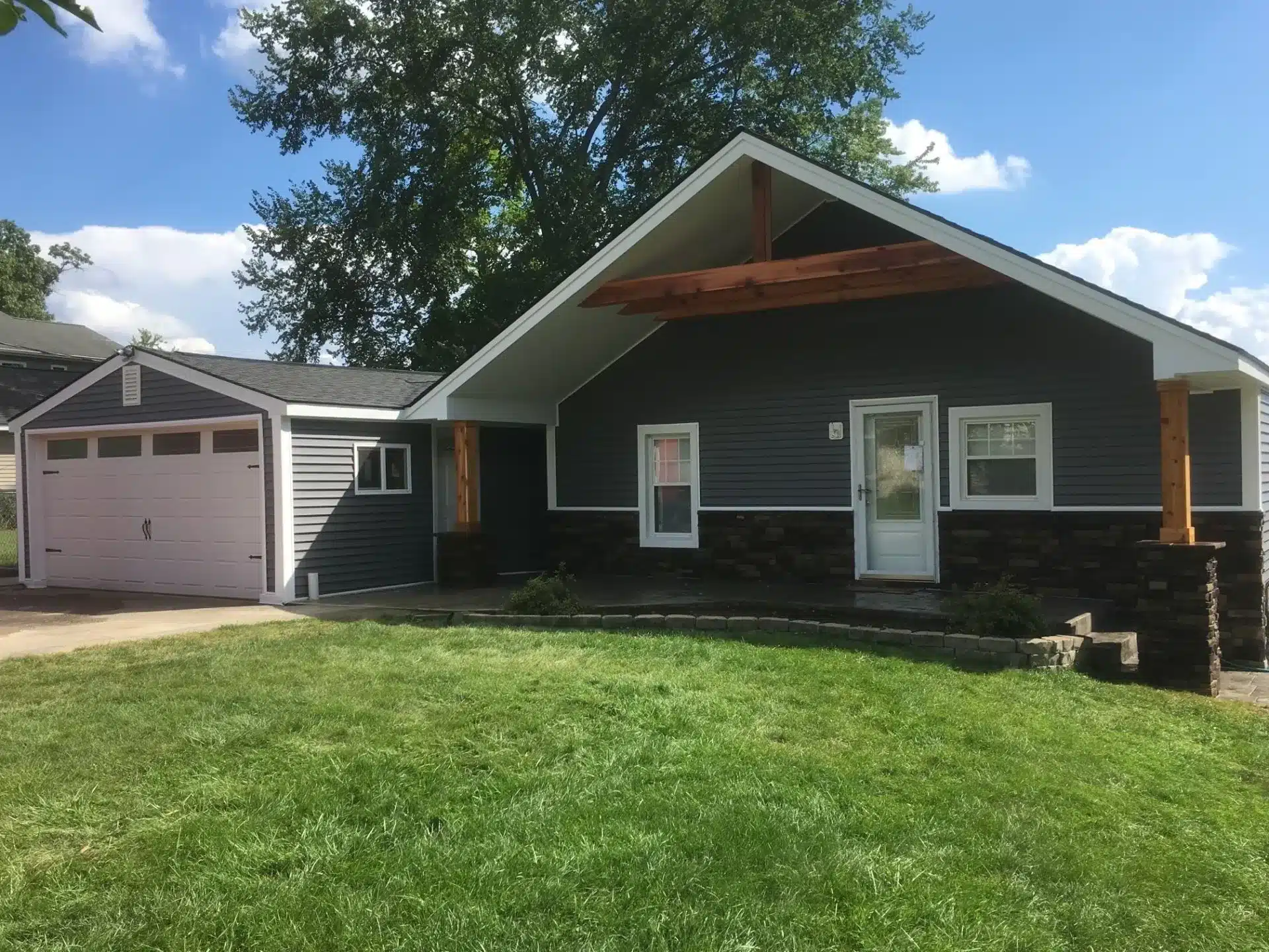 Elegant House with black siding with black roof by residential roofing contractors in Pontiac, MI.