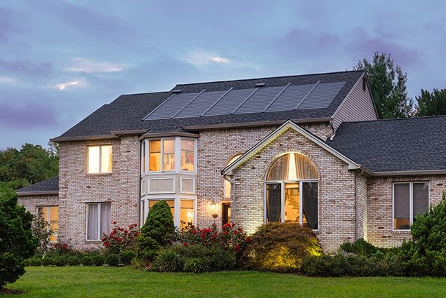 House with brick siding and Solar Shingle Installation by Performance Roofing and Siding in Michigan