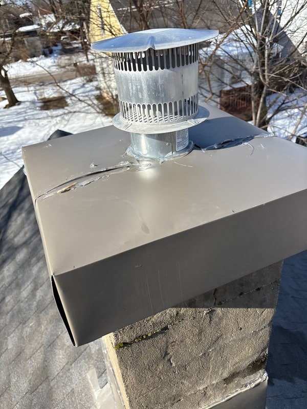 Close-up view of deteriorated chimney flashing before repair