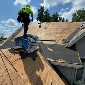 Performance Roofing and Siding staff on top of a roof in a process of roof replacement in Michigan