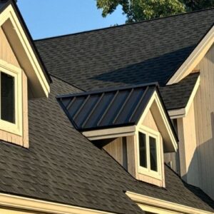 A finished roofing project with a black roof and beige siding by Performance Roofing and Siding in Michigan