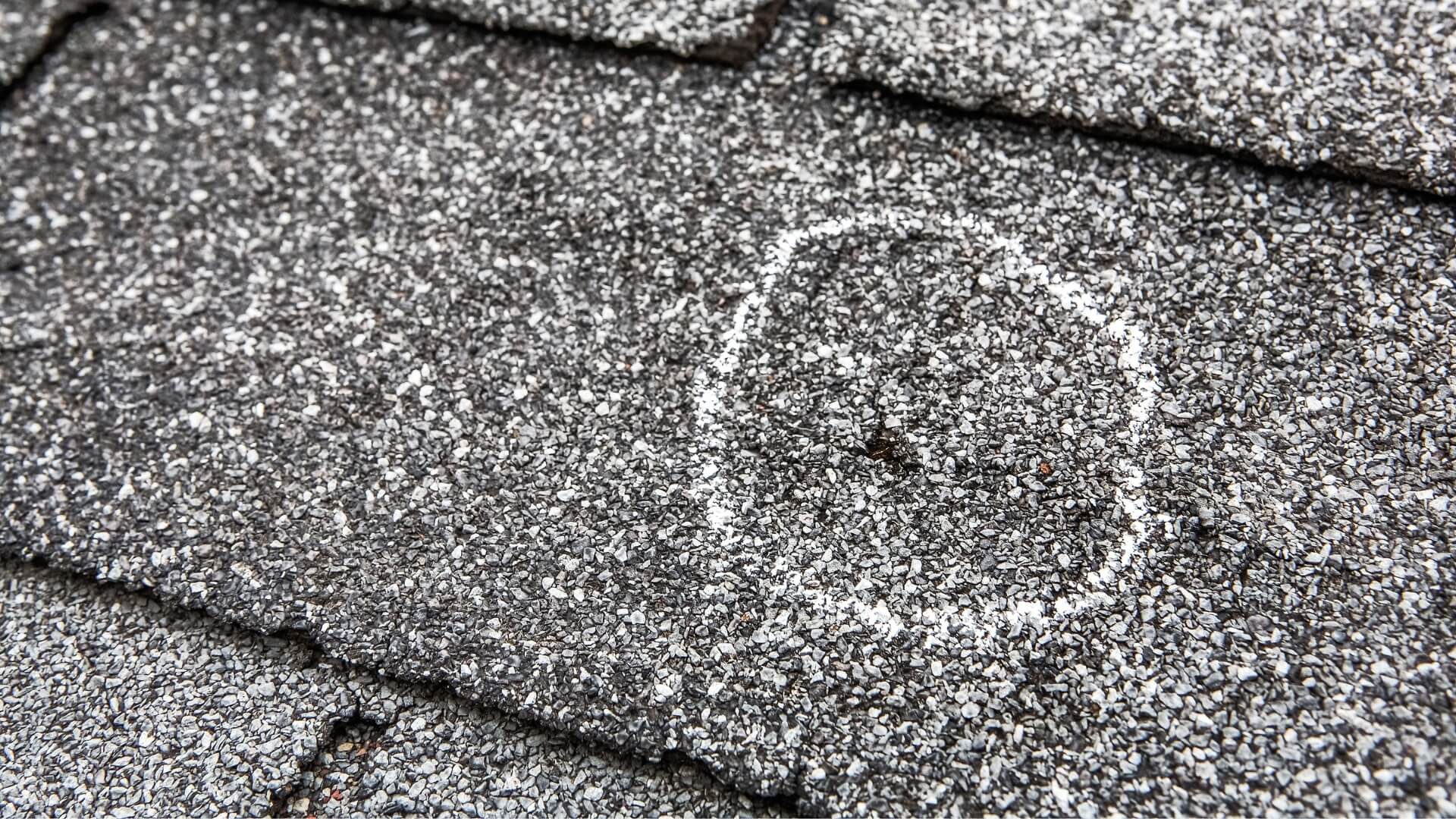 Damaged roof by hail storm that is needing roof repair services of Performance Roofing and Siding in Michigan