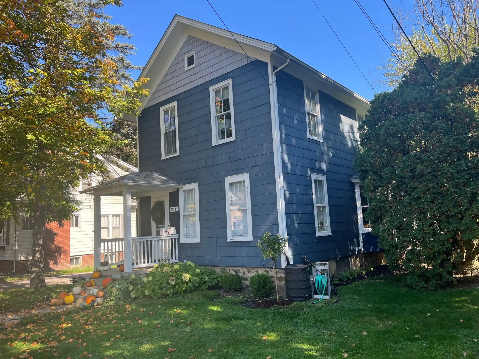 Weathered siding exterior before renovation by Performance Roofing and Siding