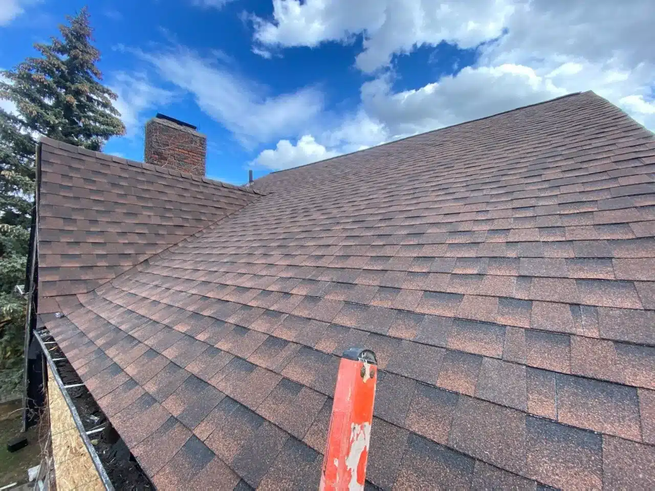 Ladder on the roof preparing for a roof inspection by Performance Roofing and Siding in Michigan