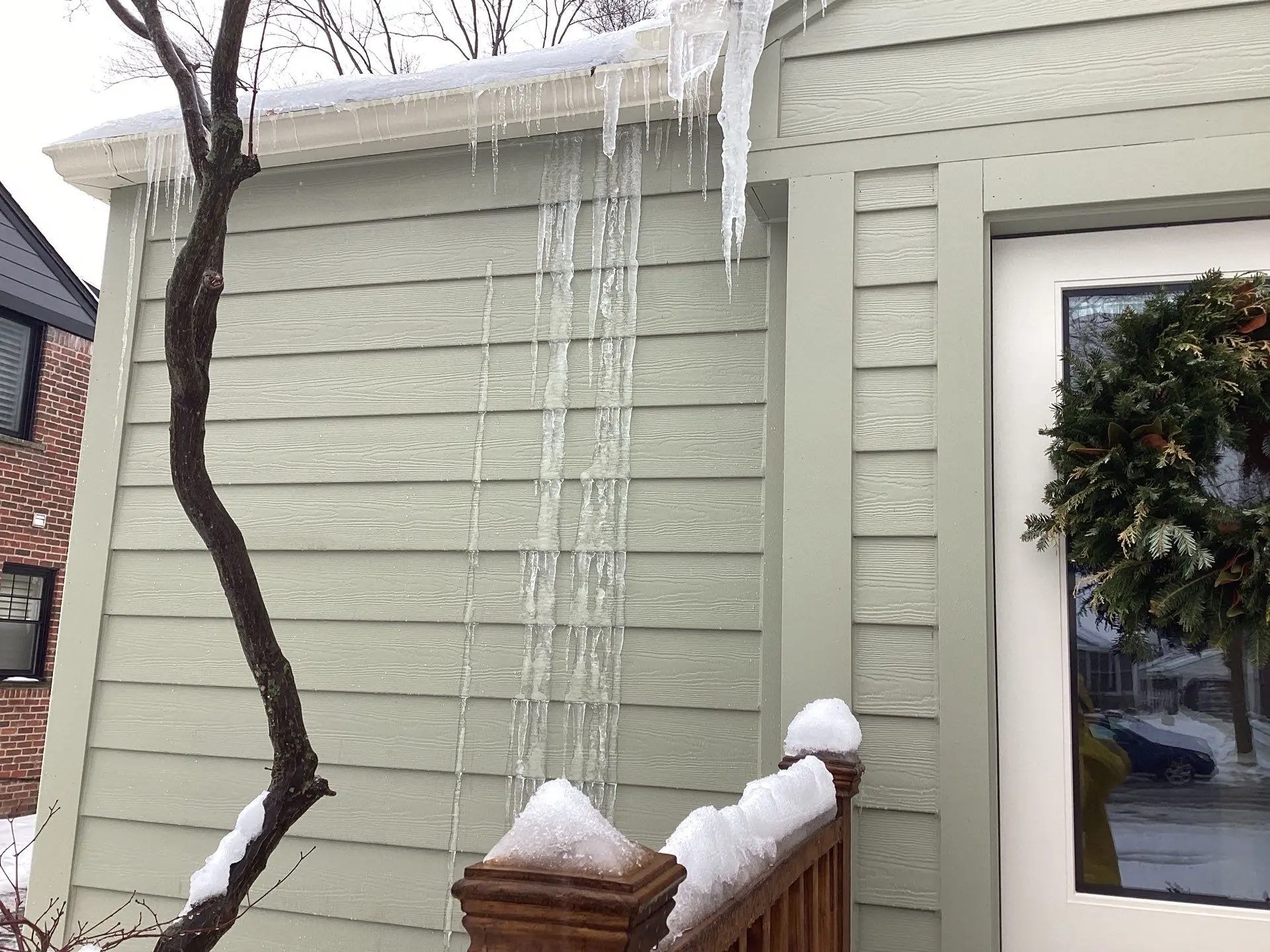Entryway siding and railing monitored for winter icicles by Performance Roofing and Siding in Birmingham, MI