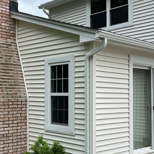 Exterior of a Michigan home showing siding and gutter system.
