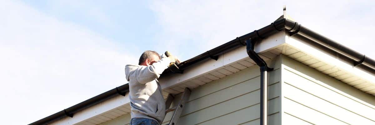Seamless gutter installation on a Michigan home by a professional roofer.