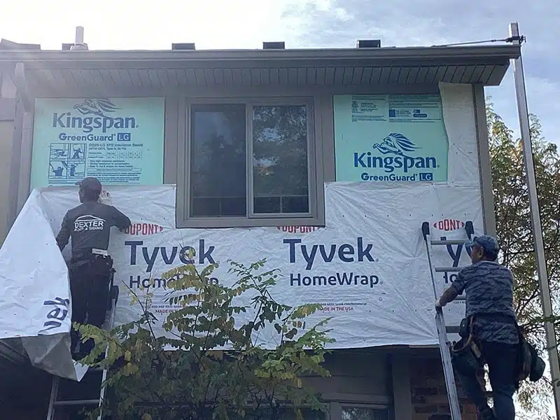 Technicians installing Tyvek HomeWrap and Kingspan GreenGuard insulation by Performance Roofing and Siding