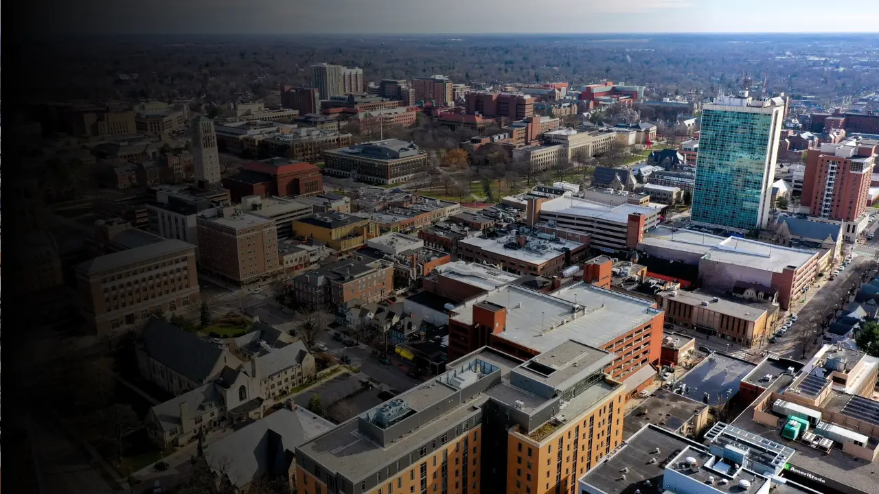 Aerial photo of downtown Ann Arbor, showcasing city buildings, high rises, and residential areas